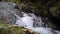 A large waterfall over some water