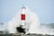 Large Wave Crashing into Breakwater Lighthouse