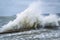 Large waves crash against the wall of the pier on the embankment of the resort city on the Black Sea