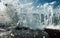 Large Waves Crash into Rock Tide pools, Throwing Foamy White Seawater Spray Into The Air In Storm