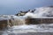Large waves from the Irish Sea during a winter storm batter the harbor wall at the long Hole in Bangor Ireland