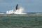 Large Waves Surround Stone Lighthouse as Sun Breaks Through in M