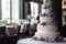 Large wedding cake on the table in the banquet hall.