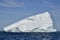 Large wedge shaped iceberg marooned in sea