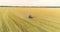Large wheat field drone view. A tractor sprays a wheat field, a top view. Protecting fields from pests