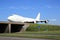 Large white aircraft crossing bridge