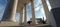 Large white columns and metal benches against the sky and backlight