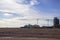 Large white cruise liner in the sandy desert near the tower cranes building modern high-rise buildings