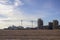 Large white cruise liners in the sandy desert near the tower cranes building modern high-rise buildings