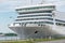 A large white cruise tourist ship moored at the pier in the passenger port