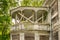 A large white decorated balcony on an abandoned building.