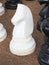 A large white horse chess pawn