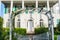 Large White House with Arbor, Trellis and White Picket Gate