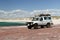 Large white offroad vehicle on the beach