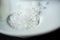 Large white sea salt scattered on a light saucer