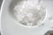 Large white sea salt scattered on a light saucer
