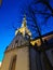 The large white St. Olaf Baptist Church on one of the streets of Old Tallinn against a dark blue sky. Spring evening