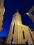The large white St. Olaf Baptist Church on one of the streets of Old Tallinn against a dark blue sky. Spring evening