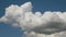 A large white thundercloud in the blue sky. Epic storm tropical clouds at sunset. 4K UHD fast shooting. in anticipation