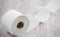 A large white toilet paper roll for use in bathrooms or kitchens, used for cleaning dirt in the bathroom background