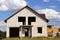 Large white unfinished brick private house with empty windows