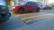 Large wide caution speed bump. Blurred motion of red car. Sleeping policeman black and yellow. Road safety regulations. Traffic ca
