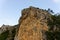 Large wild red limestone cliffs with sparse vegetation