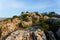 Large wild red limestone cliffs with sparse vegetation