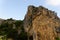 Large wild red limestone cliffs with sparse vegetation