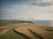 large wind farms on the green seashore generating energy for humanity