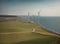 large wind farms on the green seashore generating energy for humanity