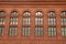 Large windows on the side of a red bricked building