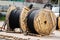 Large wire spools on the construction site. Installation of urban electrical networks. Close-up