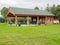 Large wood and stone pavilion in a park