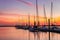 Large yacht harbor in colorful bright sunset light, luxury summer cruise, sailboats in summer sunset