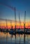 Large yacht harbor in orange sunset light, luxury summer cruise, sailboats in summer sunset