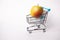 Large yellow apple in the cart for shopping. Copy space