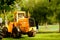 Large yellow bulldozer parked on green grass, very nice color constrasts