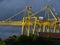 Large yellow crane in a shipyard. Cloudy sky background