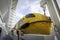 Large yellow lifeboat on side of cruise ship