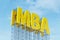 Large yellow signboard on metal frame with the word MBA