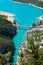 The largest European canyon Verdon Gorges with the view on the bridge and boats, pedalos on azure blue water , overlooking lake Sa