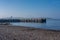 Largs Pier and the Old Harbour Wall with its Leaning Warning Post on a Bright February day on the West Coast of Scotland