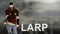 Larp word text with Warrior armed with sword viking and leather armor on a gradient background. With copyspace for your text. Larp