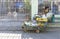 Las Pinas, Philippines - A fruit vendor rests near a gated house with his pushcart on the street.