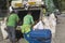 Las Pinas, Philippines - Two garbage collectors working for city hall removing trash and other waste