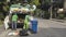 Las Pinas, Philippines - Two garbage collectors working for city hall removing trash and other waste