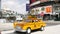 LAS VEGAS, NEVADA USA - 7 MAR 2020: Yellow vacant mini taxi cab close up on Harmon avenue corner. Small retro car model