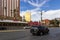 The Las Vegas strip with the Treasure Island hotel and the Trump hotel, people walking on the sidewalk and cars on the street