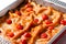 Lasagna in baking dish close-up on white background